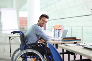 man in wheelchair at place of employment