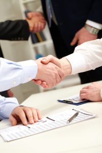business people shaking hands after successful negotiations